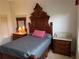 Bedroom featuring an antique bed frame, marble top nightstands, and ample closet space at 6507 Drewry'S Blf, Bradenton, FL 34203