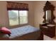 Bedroom features a large window, antique furnishings, and bed with a gray comforter at 6507 Drewry'S Blf, Bradenton, FL 34203