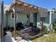 This backyard features a wooden awning and patio furniture at 6765 Laurel Ct, North Port, FL 34287