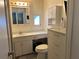 This bathroom features a toilet, vanity, sink, and cabinet storage at 6765 Laurel Ct, North Port, FL 34287