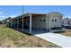 Single-story home exterior with covered parking and well-manicured lawn at 6765 Laurel Ct, North Port, FL 34287
