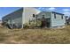 Exterior view of home and yard with established landscaping at 6765 Laurel Ct, North Port, FL 34287