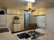 Cozy kitchen with stainless steel sink, white appliances, and ample countertop space at 6765 Laurel Ct, North Port, FL 34287