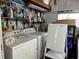 This laundry area has a washing machine, dryer, and cleaning supplies at 6765 Laurel Ct, North Port, FL 34287