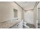 Bathroom featuring a shower, a sink with granite countertops, and gray wood-look floors at 6803 Amoko Ct, North Port, FL 34287