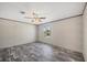 Bedroom featuring gray wood-look floors, a ceiling fan, and a sunlit window at 6803 Amoko Ct, North Port, FL 34287