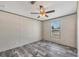 Inviting bedroom featuring wood-look flooring, a ceiling fan, and natural light from the window at 6803 Amoko Ct, North Port, FL 34287