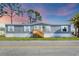Charming single-story home featuring a well-maintained yard and neutral-colored siding at 6803 Amoko Ct, North Port, FL 34287