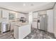 Bright kitchen features stainless appliances, stone counters, a central island and wood-look floors at 6803 Amoko Ct, North Port, FL 34287