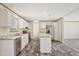 Open kitchen features stainless appliances, stone countertops, island and modern wood-look floors at 6803 Amoko Ct, North Port, FL 34287