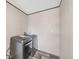 Laundry room featuring a front loading washer and dryer with gray wood-look floors at 6803 Amoko Ct, North Port, FL 34287