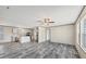 Open-concept living area featuring durable laminate flooring and lots of natural light at 6803 Amoko Ct, North Port, FL 34287