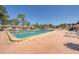 A pristine community pool with lounge chairs offers a relaxing outdoor oasis on a sunny day at 6803 Amoko Ct, North Port, FL 34287