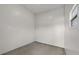 An empty room with a window and light colored concrete floors at 6803 Amoko Ct, North Port, FL 34287