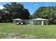 Single story home featuring a large lawn and shade trees at 751 Arabian Cir, Nokomis, FL 34275