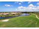 Aerial view of a beautiful home on the lake showcasing golf course views at 872 Macaw Cir, Venice, FL 34285
