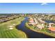 An aerial view showing a charming home on the lake with golf course views at 872 Macaw Cir, Venice, FL 34285
