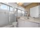 Bright bathroom featuring a glass-enclosed shower, neutral color palette, and a spacious vanity area at 872 Macaw Cir, Venice, FL 34285