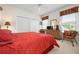 Comfortable bedroom featuring natural light, window treatments, a ceiling fan, and dual closets for storage at 872 Macaw Cir, Venice, FL 34285