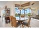 Cozy breakfast nook overlooking the pool area through expansive screened windows at 872 Macaw Cir, Venice, FL 34285