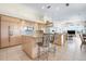 Modern kitchen boasts light wood cabinetry, granite countertops, and stainless steel appliances at 872 Macaw Cir, Venice, FL 34285