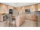 Modern kitchen with granite countertops, stainless steel appliances, and center island with seating at 872 Macaw Cir, Venice, FL 34285