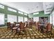 This is a spacious library with many bookshelves and tables with chairs for residents at 872 Macaw Cir, Venice, FL 34285