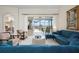 Bright living room featuring comfortable seating, sliding doors to the pool, and elegant decor, creating an inviting space at 872 Macaw Cir, Venice, FL 34285