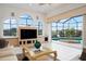 Cozy living room boasts scenic views of the pool, outdoor patio, and lush landscaping at 872 Macaw Cir, Venice, FL 34285