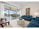 Bright living room featuring comfortable seating, sliding doors to the pool, and elegant decor, creating an inviting space at 872 Macaw Cir, Venice, FL 34285