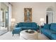 Cozy living room featuring stylish furniture, an elegant painting, and soft lighting, perfect for relaxation at 872 Macaw Cir, Venice, FL 34285