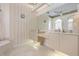Bright primary bathroom offering double vanities, a makeup area, and marble floors with a large framed mirror at 872 Macaw Cir, Venice, FL 34285