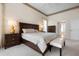 Spacious main bedroom featuring a ceiling fan, bedside tables, and a doorway to a walk-in closet at 872 Macaw Cir, Venice, FL 34285