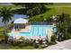This refreshing pool has several lounge chairs and umbrellas, along with views of a lake at 872 Macaw Cir, Venice, FL 34285