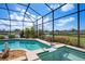 Screened-in swimming pool and spa offering an amazing view of the green outdoors at 872 Macaw Cir, Venice, FL 34285