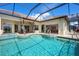 Scenic screened-in swimming pool and spa area with access to the home and waterfront views at 872 Macaw Cir, Venice, FL 34285