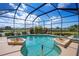 Enclosed swimming pool with a spa, manicured landscaping, and beautiful water views at 872 Macaw Cir, Venice, FL 34285