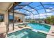 Beautiful in-ground pool and spa area enclosed with screen, offering scenic lake views at 872 Macaw Cir, Venice, FL 34285
