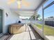 Covered back porch featuring hot tub, barbecue and tile flooring at 985 Everest Rd, Venice, FL 34293