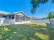 Fenced backyard with lawn and covered patio at 985 Everest Rd, Venice, FL 34293