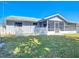 Fenced backyard with lawn, white picket fence and covered porch at 985 Everest Rd, Venice, FL 34293
