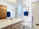 Bright bathroom featuring a single sink vanity, framed art, and a glass-enclosed shower at 985 Everest Rd, Venice, FL 34293