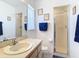 Bright bathroom featuring a single sink vanity, framed art, and a glass-enclosed shower at 985 Everest Rd, Venice, FL 34293