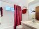 Cozy bathroom showcasing a tiled tub-shower combination and a single sink vanity at 985 Everest Rd, Venice, FL 34293