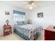 Bright bedroom with a comfortable bed, side tables, and nautical-themed décor at 985 Everest Rd, Venice, FL 34293