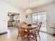 Inviting dining area with wood table set, tiled flooring, a sliding glass door, and open access to the kitchen at 985 Everest Rd, Venice, FL 34293