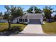 Charming single-story home featuring a well-manicured lawn, attached two-car garage, and screened-in porch at 985 Everest Rd, Venice, FL 34293