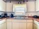 The kitchen features white cabinets, a stainless steel sink, and a window that provides natural light at 985 Everest Rd, Venice, FL 34293