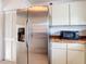 The kitchen features a stainless steel Samsung refrigerator and a black microwave at 985 Everest Rd, Venice, FL 34293
