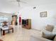 Inviting living room with vaulted ceiling, tiled floors, and comfortable seating area at 985 Everest Rd, Venice, FL 34293